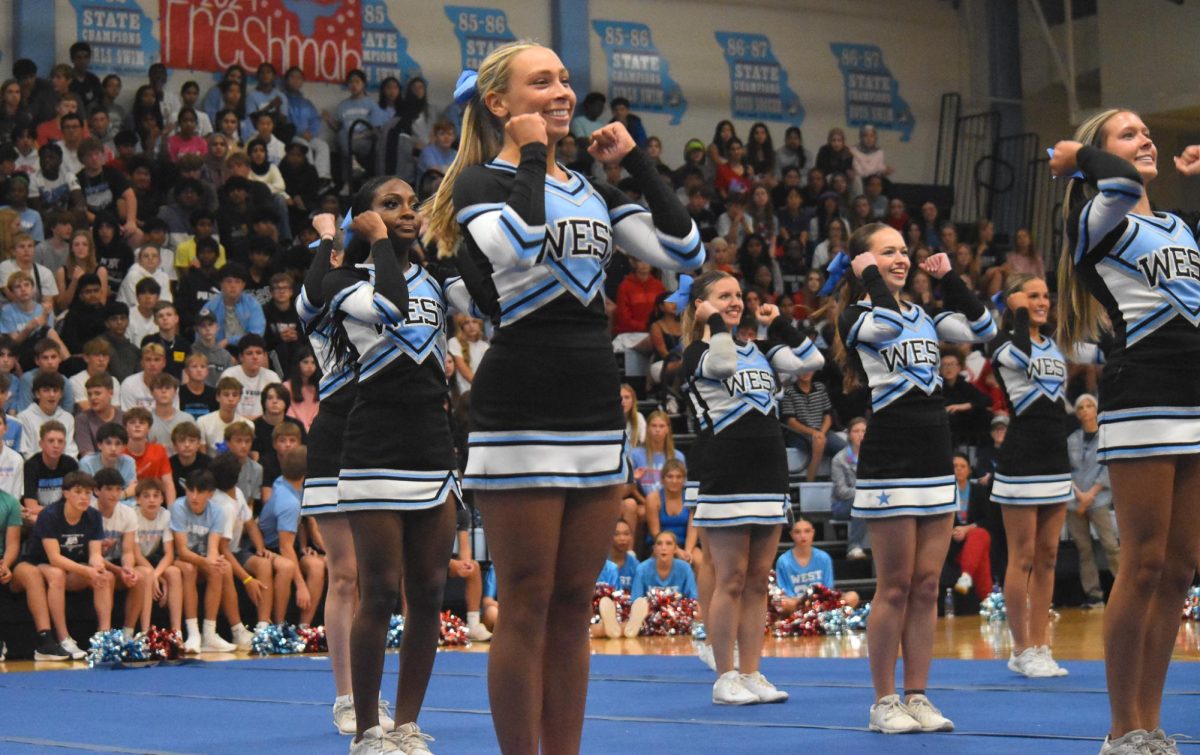 Performing her last routine, senior Jordyn Hopper cheers alongside her varsity teammates. The team prepared for this performance since the summer. “[This year was] kind of stressful, but super exciting. I loved this team. They are all my best friends. It was really exciting seeing everything finally come together, [since] we had been practicing for so long,” Hopper said.
