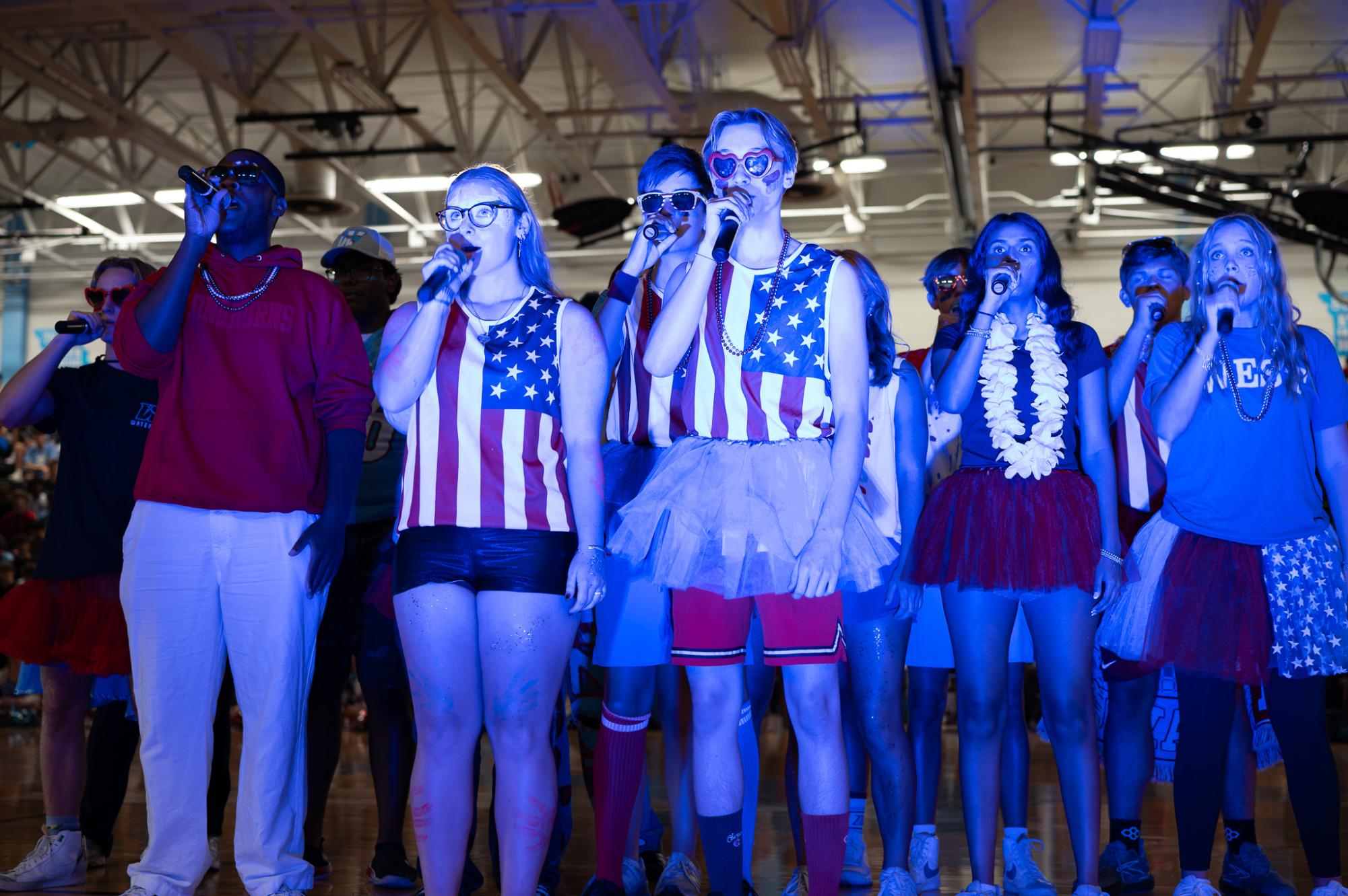 Blue lights shining brightly, senior Riley Creely beatboxes into the microphone. Creely and the group began the performance in front of the blue lights, sparking interest from the audience. “The pep rally performance was fun. I got to beatbox for the first half of the song, which was hype. I liked to look into the student section [while I performed],” Creely said. 