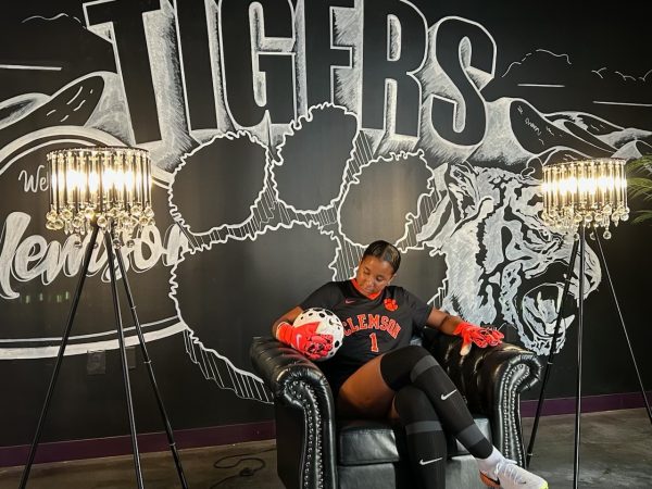 Eyeing the ball, junior Ella McNeal poses for her commitment pictures at Clemson University. McNeal’s commitment comes after months of contact with top Division 1 soccer programs. “ It has taken a lot to get to where I am, but I know that [what] I've already been through is just the beginning, and I can't wait for what is to come,” McNeal said. 