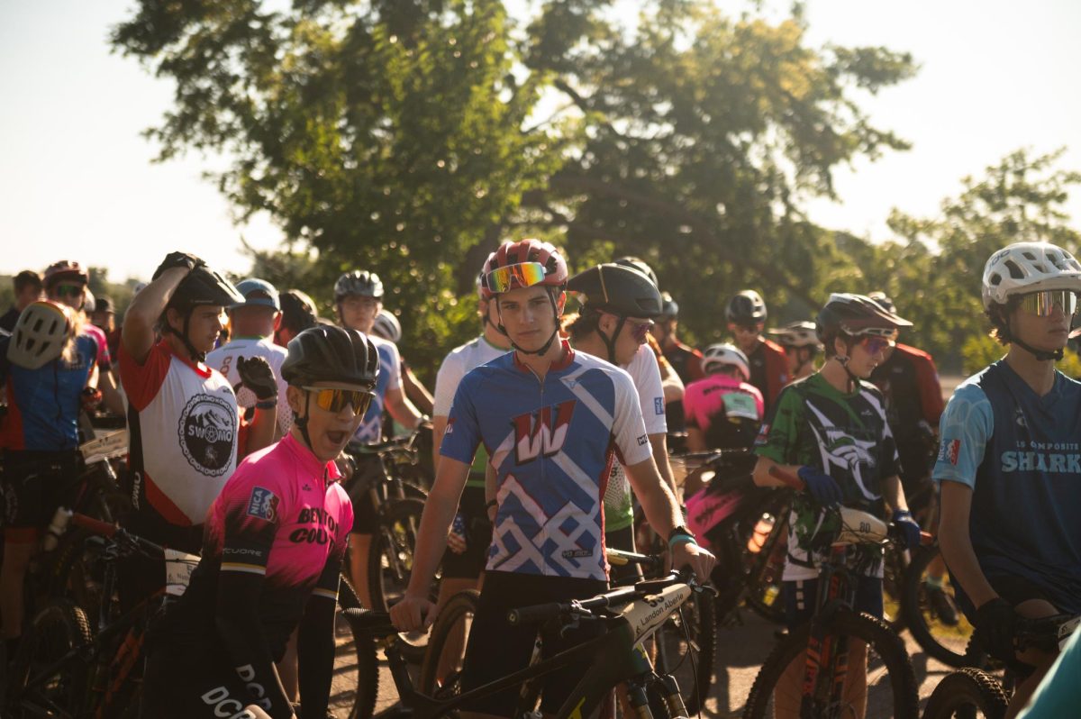 Lining up in the staging area before his start time, junior Landon Aberle mentally prepares himself for the start of the Binder Lake Bash race on Aug. 7. In the minutes before his race, a pair of riders were involved in a car accident. Aberle wanted to show his support and emphasize the National Interscholastic Cycling Association (NICA) value of community. “The race was going well for me and my friend physically, but it hurt knowing that other people weren't there. That's all we cared about, and when we knew one of them was okay, we decided to keep going and finish the race for them,” Aberle said.