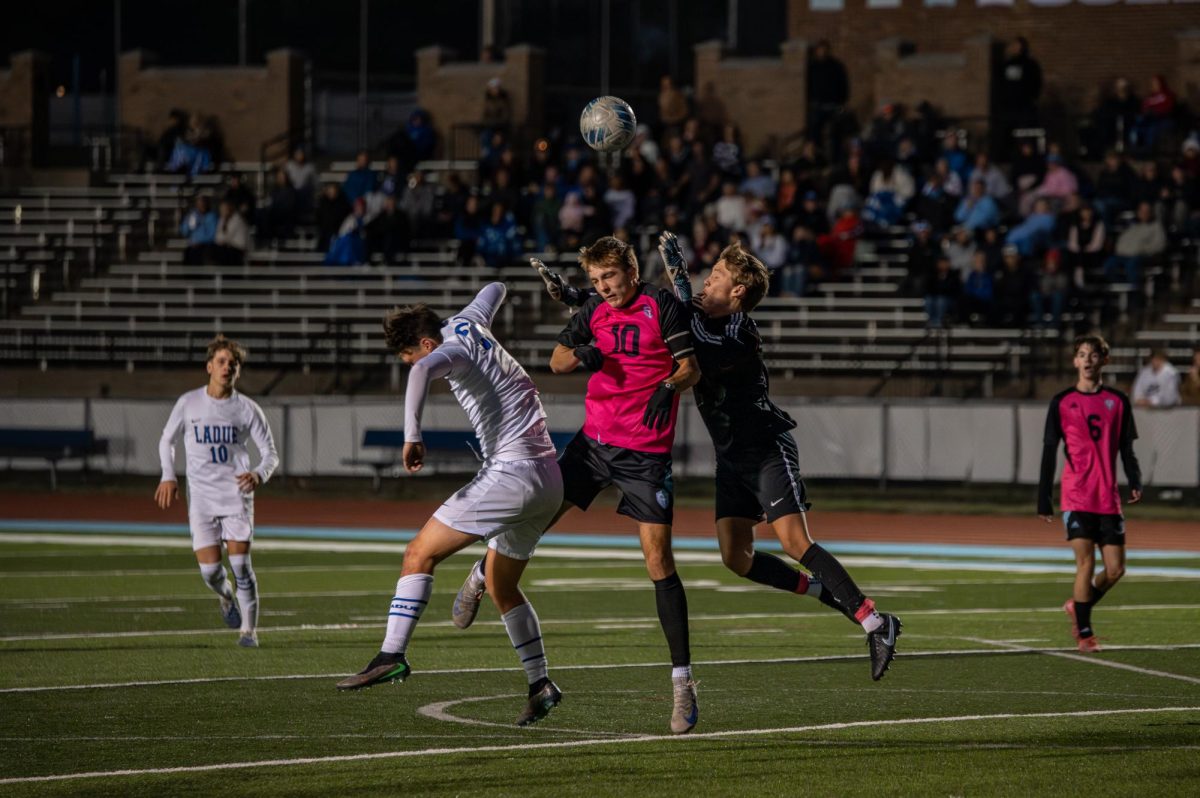 Mid-air, junior Donovan Qualls leaps for the soccer ball during the varsity game against Ladue on Oct. 21. As the goalie, Qualls focused on keeping the ball away from the box and the back of the net. “[Being a goalie] is pretty tough. You have to be the commander of the team in your box, step up for your team, be loud, and have a lot of communication. Once you do it for a while, it gets fun. I really enjoy being the backbone of my team,” Qualls said.
