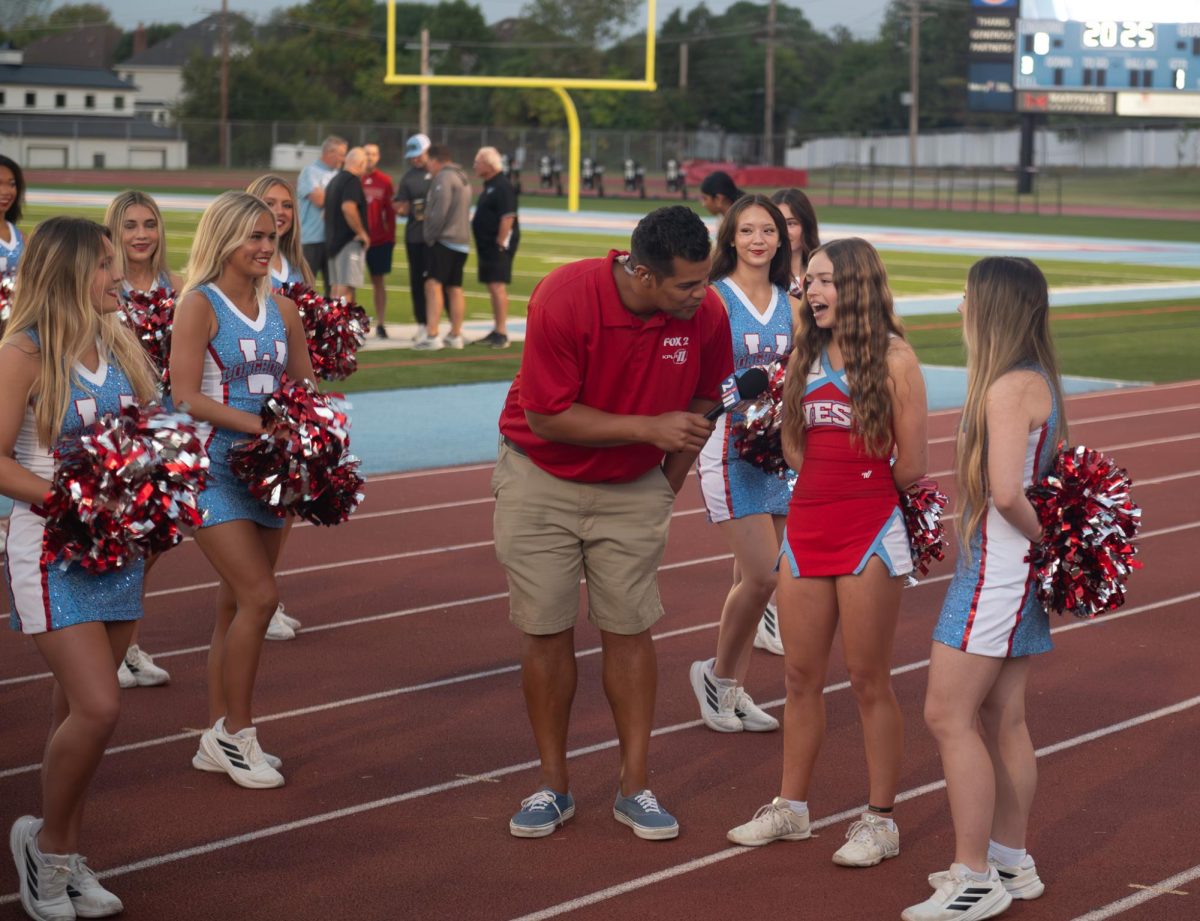 Talking with Fox 2 News reporter Ty Hawkins, senior Shea O’Connell represent the varsity cheer team during a live interview. This is O’Connell’s last year cheering with the team. “It felt really amazing just knowing that my team trusted me enough to represent them. I enjoyed [being] able to share the bond between the cheer team because I've been cheering with some of these girls for for seven years and some of them for three years. I loved being able to do this with [my] amazing friends on the team,” O’Connell said. 