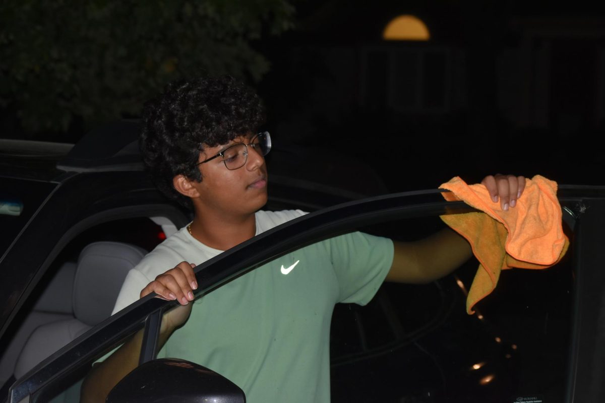 Focused on providing exceptional service, sophomore Darsh Mahapatra carefully cleans the door of a customer’s car. Mahapatra has always believed his customers deserve nothing less than the best. “[If] they’re trusting us with their car and our service, then I am convinced that they deserve our 100 percent effort and beyond,” Mahapatra said.