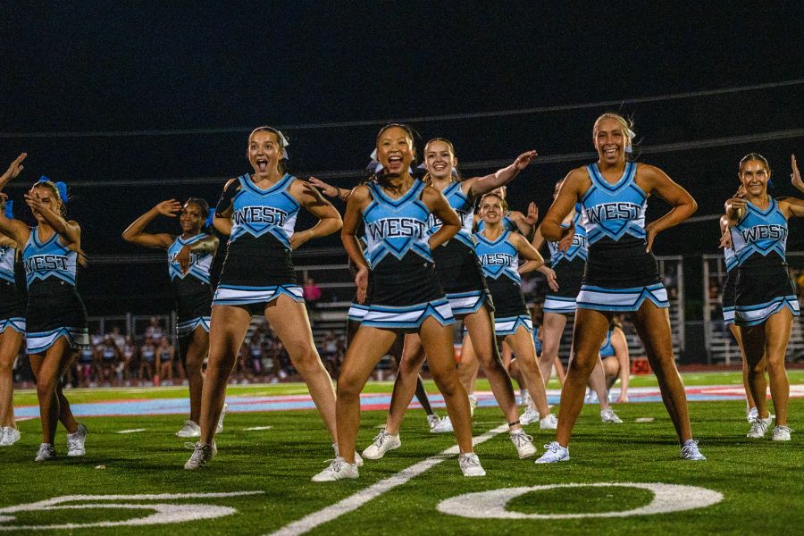 Standing tall, stacked in a precise formation, the cheer team strikes a signature pose during halftime on Sept. 12 at the varsity football game. Nearly a month after this performance, the cheer team performed at the Missouri Cheerleading Coaches Association (MCCA) regional competition on Oct. 4, 2025. “We've all come [to] work together a lot more,” sophomore Elyssa Philippi said. “We're a lot closer than we were [earlier in the season] and going to state has made us closer [in] trying to work with each other, learn [new] skills and make our team better.” 