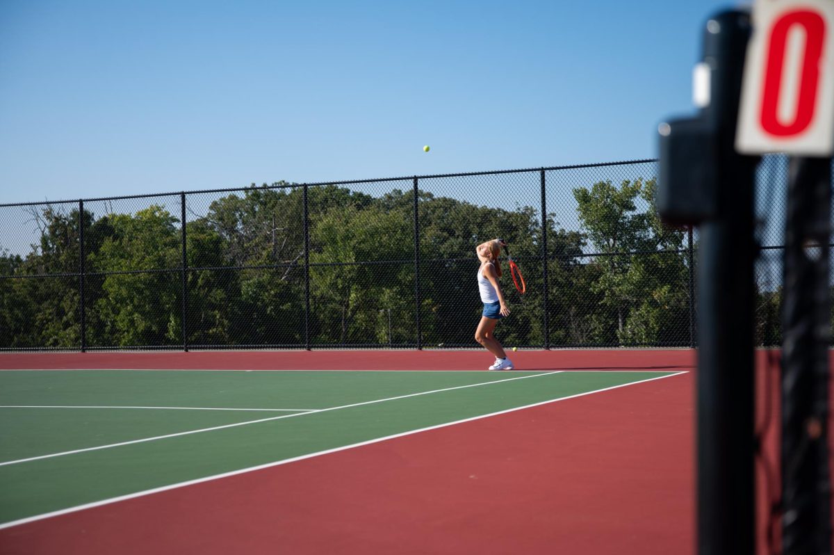 Swinging her racket back and getting ready to strike the ball, senior Kate Johnson goes through her routine to serve the tennis ball. Johnson is in her fourth year of playing tennis and served as a captain. “I think I have improved so much since freshman year. My serve has gotten a lot better. I just feel more confident in my game,” said Johnson.
