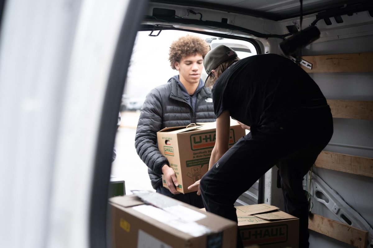 Helping to transport cans and other food items from West High’s food drive to the Parkway Food Pantry, sophomore Max Jones carries a box into a truck. Nov. 21 marked the end of West High’s annual canned food drive. “The food drive is a really great opportunity for everyone to get involved in helping a bigger cause. It’s great that [the West community] can make a difference in a big way through this food drive,” Jones said. 