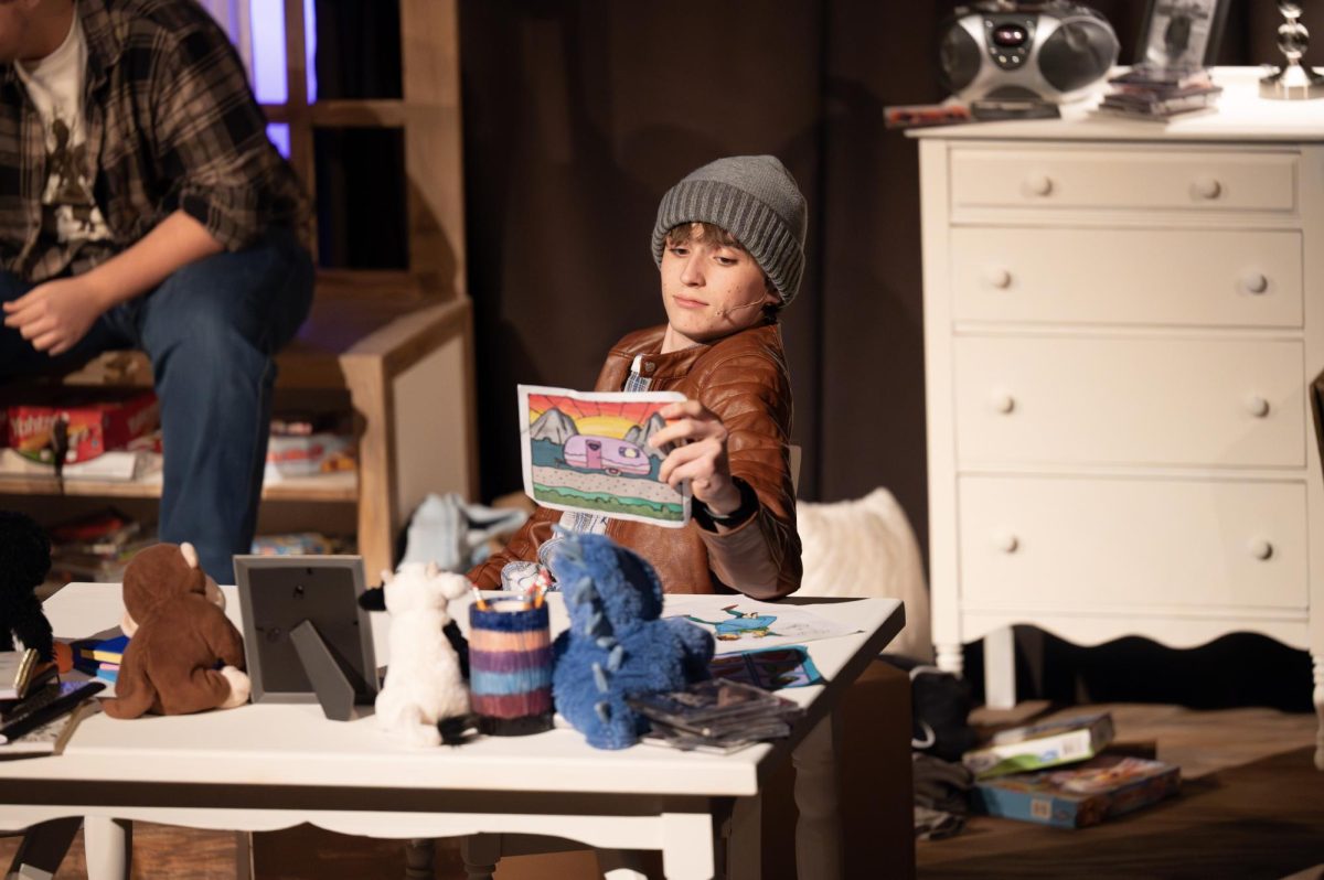 Performing as Nibs in “Lost Girl,” junior Avery Hermann inspects a drawing of Neverland made by the show’s main character, Wendy Darling. Hermann not only acted in “Lost Girl”, but he also served as assistant director of the show. “I found ‘Lost Girl’ to be a beautiful and touching story, and I’m really glad I got to be a part of it. My favorite part of the show [was] my work as assistant director. I spent a lot of time working with every [cast member] on character, deliveries and emotional development. It was so amazing to see these brilliant actors come to life on stage in such a colorful way,” Hermann said.