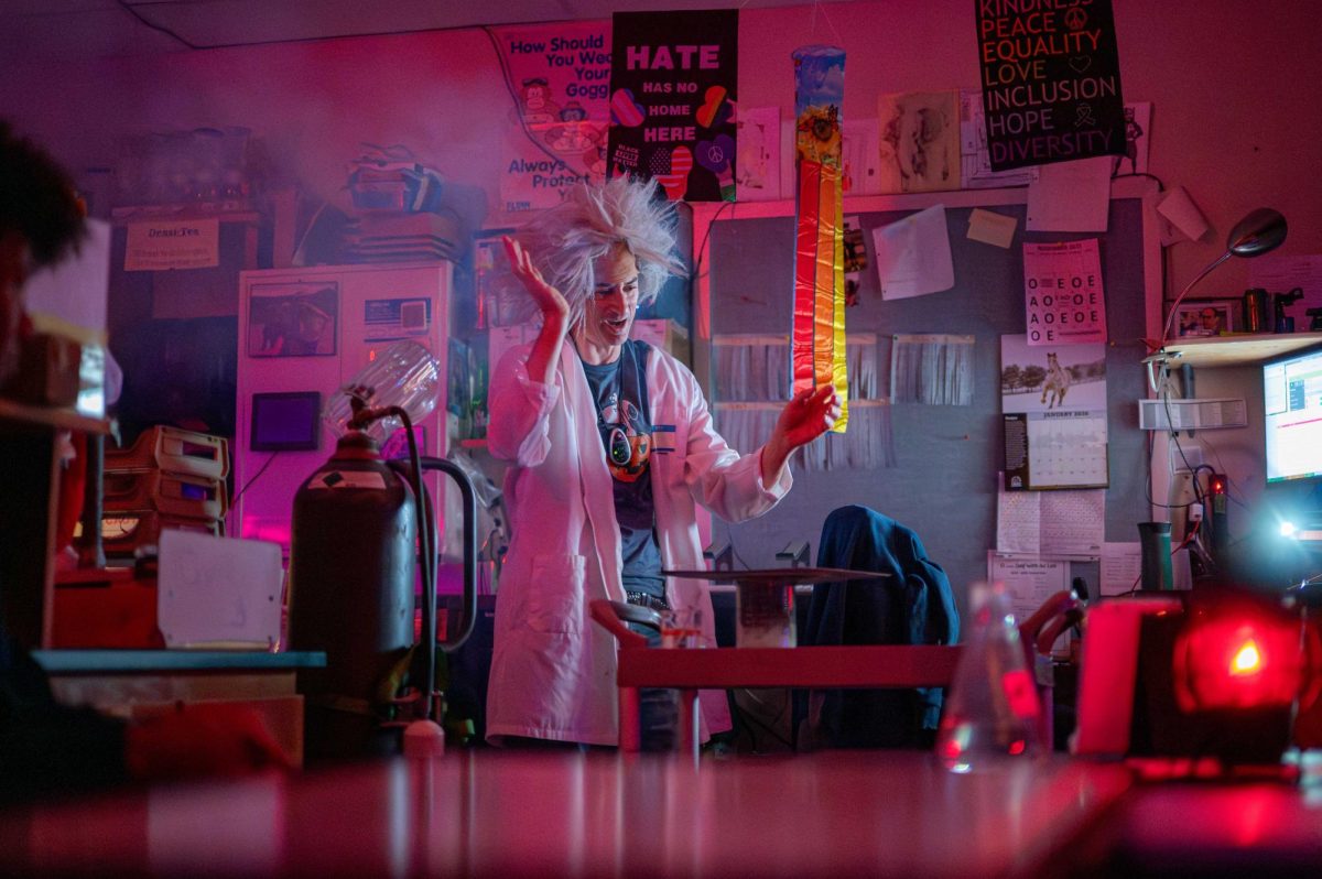 Between lights, smoke and a captive audience of students, science teacher Joel Anderson conducts his annual Halloween show in class on Oct. 31. Anderson has performed the Halloween show every year for 27 years, since he started teaching in 1999. “[My favorite part about the show] is getting students excited about it and seeing their level of anticipation. After the students see it, they realize that [I] put a lot of time and effort into it,” Anderson said. “They also end up learning because I sneak some chemistry into the [show] as well. So, it’s a whole bunch wrapped up in a 15 or 20-minute package. It’s really scary.”