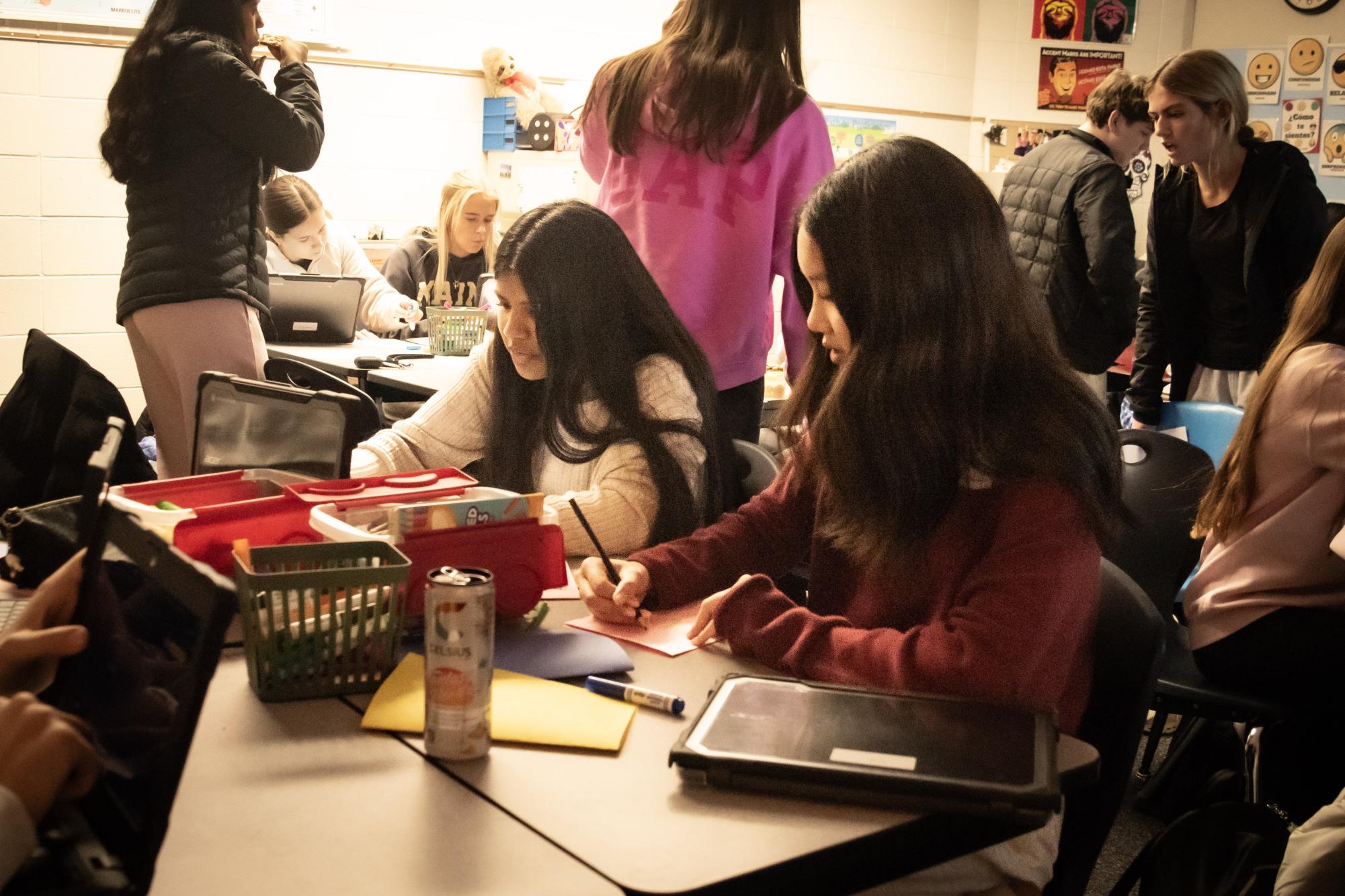 Coloring on a sheet of paper while chatting with her friends, freshman and member of Tiny Smiles Club, Ella Dao creates a card for hospitalized children across the nation.