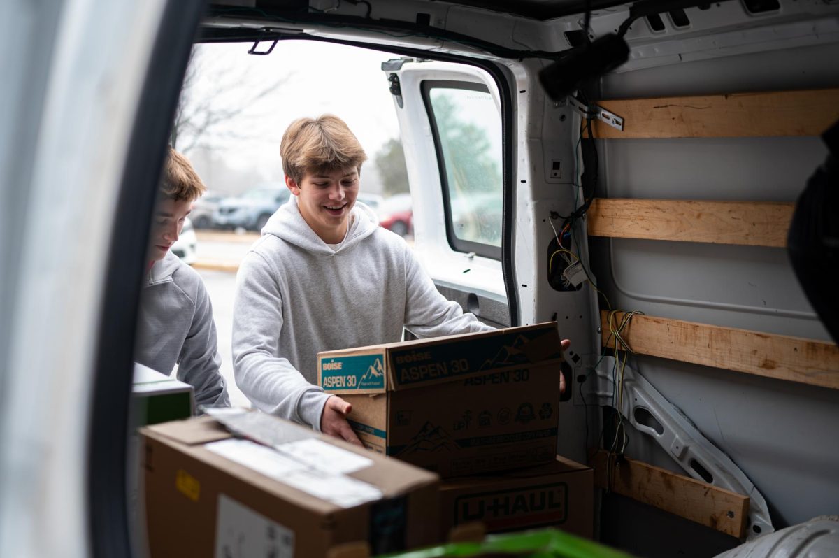 Lifting a box of canned goods, sophomore Liam Mouser loads into the van a fraction of the 4,906 cans donated during the Feed the Herd campaign with the Parkway Food Pantry. This year, the Social Studies department competed with the English department as students brought in cans to support Parkway families, and teachers offered rewards such as extra credit or a movie day to motivate donors. “I donated last year, so I wanted to [help out] again. I got extra credit for [donating] 15 cans, and it makes me happy to help people who need it. It’s nice to know I did a good thing,” Mouser said.