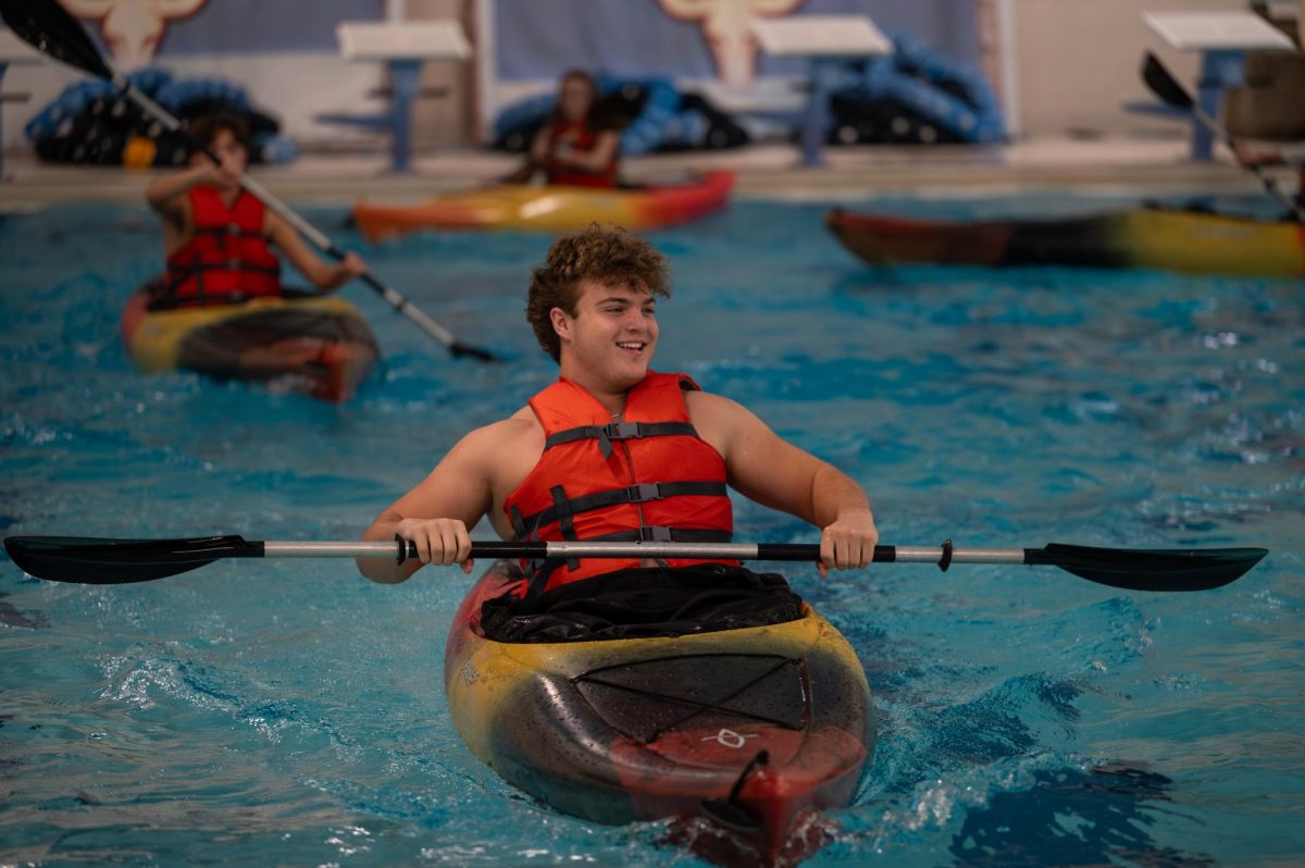 Paddling through the pool, junior Nicholas Hayek laughs with his friends as they attempt to kayak for the first time. Hayek chose to take Adventure pursuits so he could have a break in his day from the typical in-classroom setting and get outdoors with friends. “I was in Adventure Pursuits, and we were kayaking. It's definitely a [unique] class in the building, and it teaches [students] a lot of valuable things that [they] probably don't know, like fire building, and all the important outdoor skills,” Hayek said.