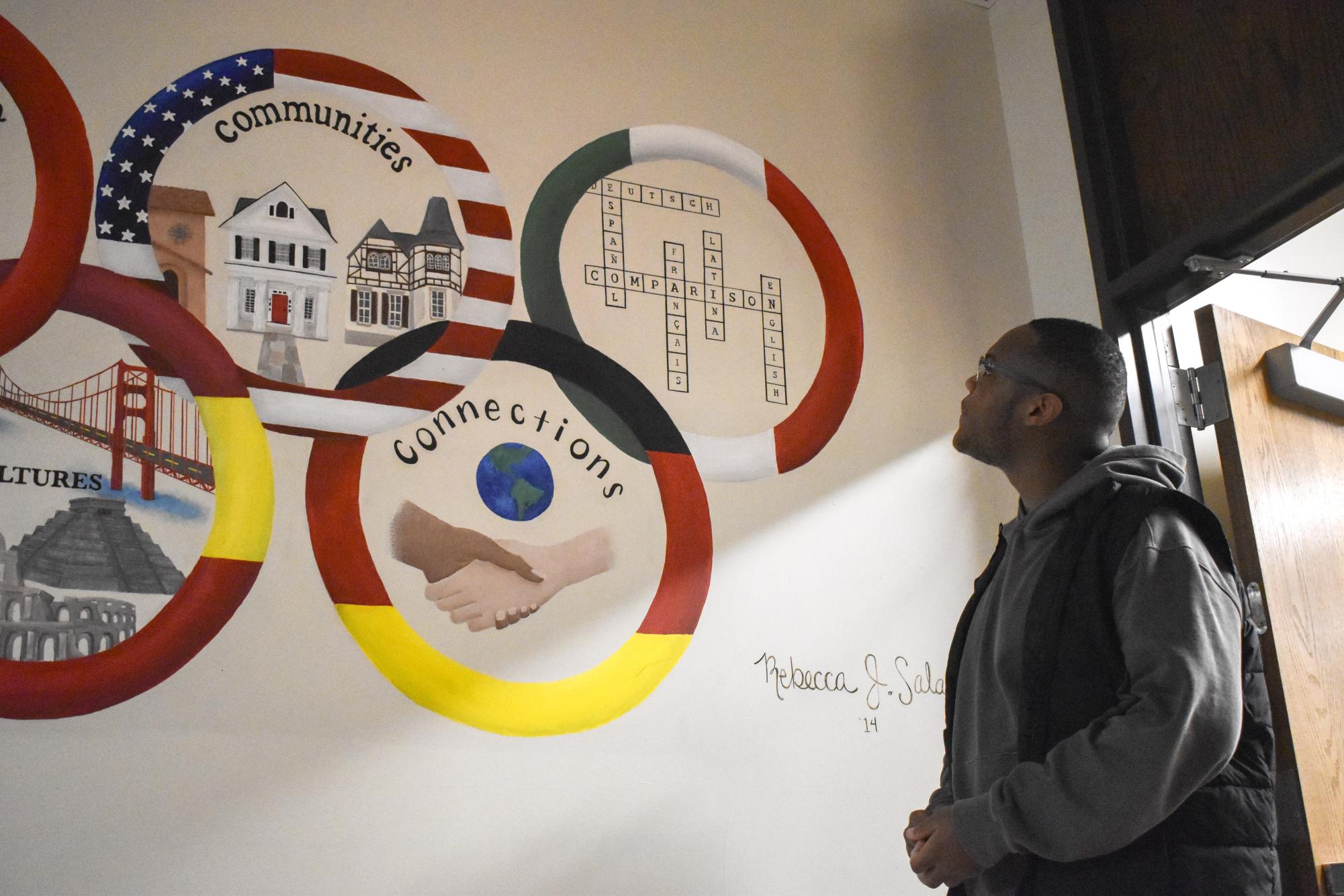 Reflecting on the hallway artwork titled “Community and Connections,” junior Trent Young is inspired by the unity and belonging showcased at school. This painting was created in 2014 to represent West's diverse population.“Seeing someone of color, [Zohran Mamdani], succeed in politics makes me realize I belong here. It inspires me to get involved within my community [to] make a difference,” Young said. 