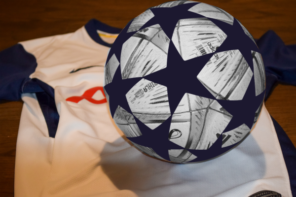 A soccer ball rests on top of a Tottenham Hotspur’s home jersey.