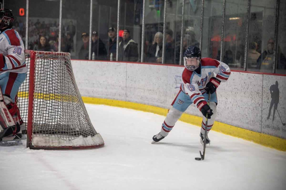 Setting up for a pass, junior Chase Waddell looks down the ice to find an open teammate to pass the puck to. Waddell stepped up in game one against Summit as the playoffs meant there was so much more on the line for this team. “That was during the playoffs, it was game one against Summit. This shot was late in the second. I came up from the other half, and the other team went for a change, and I got the puck and was able to hit it to Evan. I am a team guy, not a me guy, so it didn't really matter how I played but how the team played,” Waddell said. 