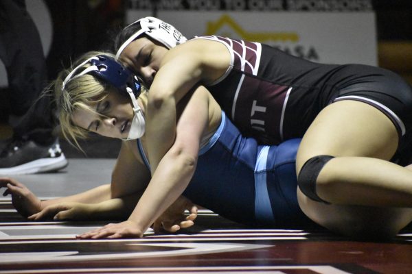 With every second on the mat counting, junior Jaeda McRaven struggles against her opponent in a wrestling match. On Dec. 9, McRaven competed at a girls' wrestling tournament at Rockwood Summit. “I have been doing pretty well this season, [especially] with being able to place on the podium at some matches, but overall, [I] have been trying very hard to [qualify] for state,” McRaven said.