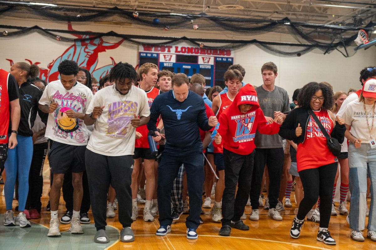 Senior Dashawn Horskins does “The Cha Cha Slide” alongside principal John McCabe and the senior class. To end the spring pep rally, McCabe called all grade levels to join him on the gym floor. “[My favorite memory from the pep rally was] when we all did the ‘Cha Cha Slide’ at the very end. McCabe called us to the court, and we all started [dancing] next to him. Something [I’ll] remember about this moment was my classmates [and me] just having fun together. It was sad [knowing this was my last pep rally] because a lot of the pep rallies I’ve been to have been fun,” Horskins said.