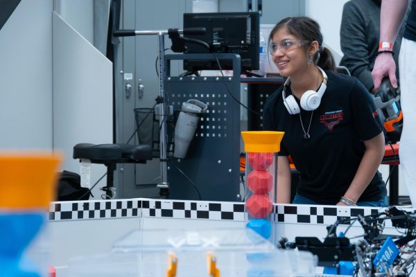 Smiling at her teammates, freshman Angela Diosdado works on her state robot. As a freshman and mechanic for the robotics team, the Blue Brains, Diosdado’s dedication has already been contributing to the team’s success. “[State] was really fun and we did pretty good, [but now] we really have to focus on Worlds. I know that our teamwork and [the fact that we have each other’s backs] will make [our goals] happen,” Diosdado said. 