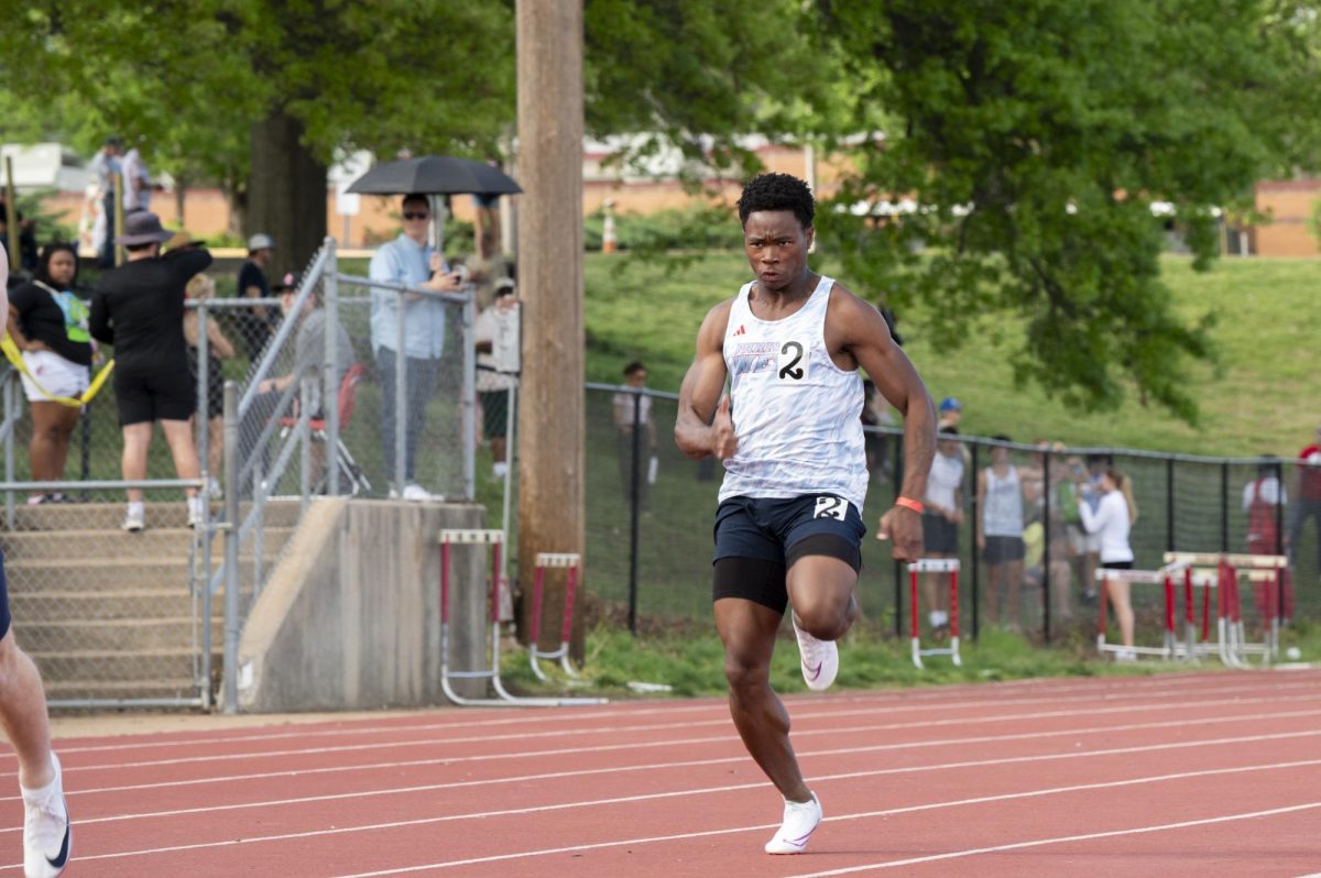 Sprinting down the line, senior Neiyo Hagen completes his 100-meter run during the April 16 meet at Parkway Central High School. Hagen was part of the track and field team at his previous school and has since joined and competed with West’s varsity team. “I am going to miss being [part] of the track and field team, because even though I have been running for only two years, I have made a lot of friends,” Hagen said. 