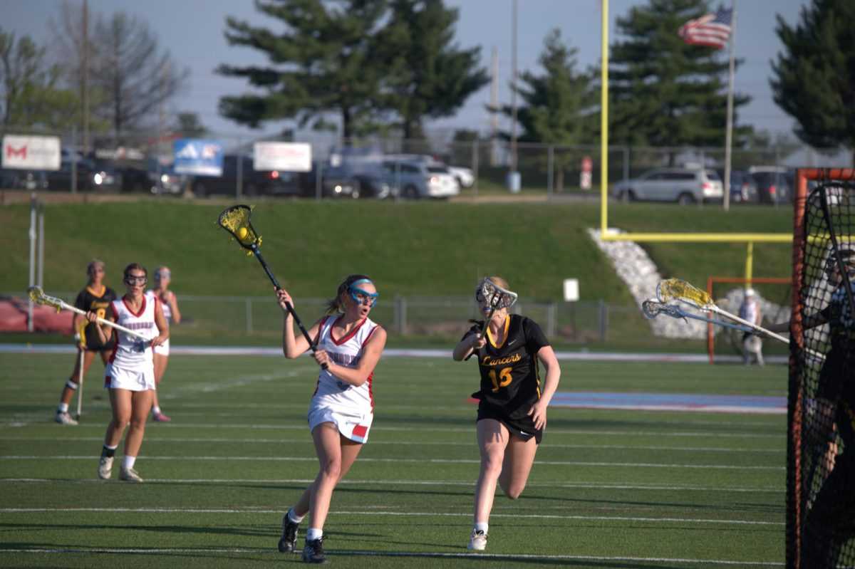 Charging towards the goal, junior Gabriella Pupillo poises her stick to shoot at the goal during the April 8. match against the Lafayette Lancers. At the end of this game, Pupillo was awarded the honor of player of the match by her coaches. “I have always enjoyed being able to bond with the team. This season feels different than others because we are all [so] close and get along so well. I will miss all of the seniors who are leaving this year, but I am excited for what is ahead.” Pupillo said. 
